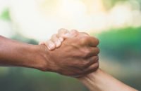 Helping, Rescue, Friendship concept. Hand gestures help in natural background and sunlight.